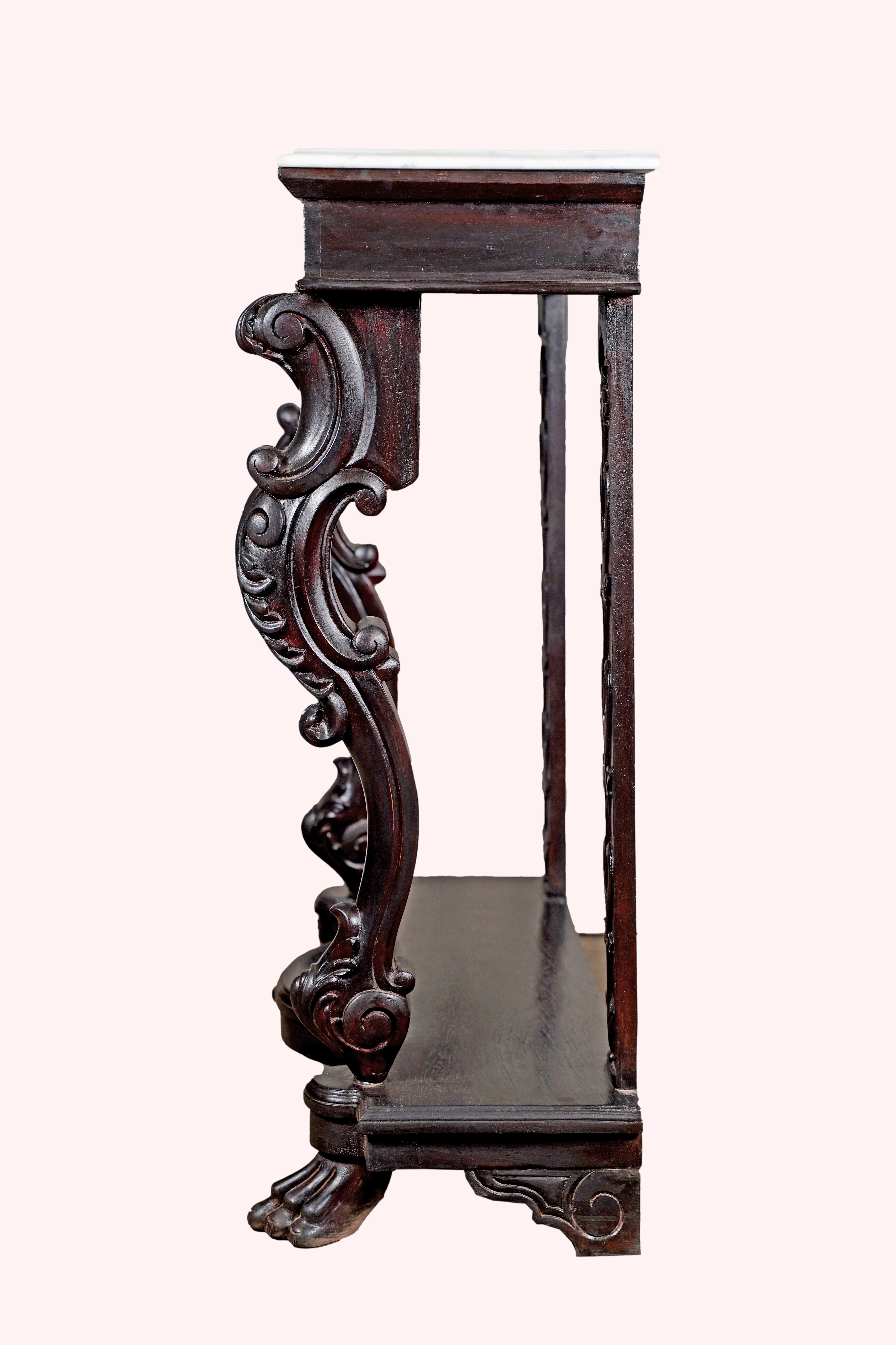 Side profile of carved wood and marble console table against pastel background – Aartaa Decor