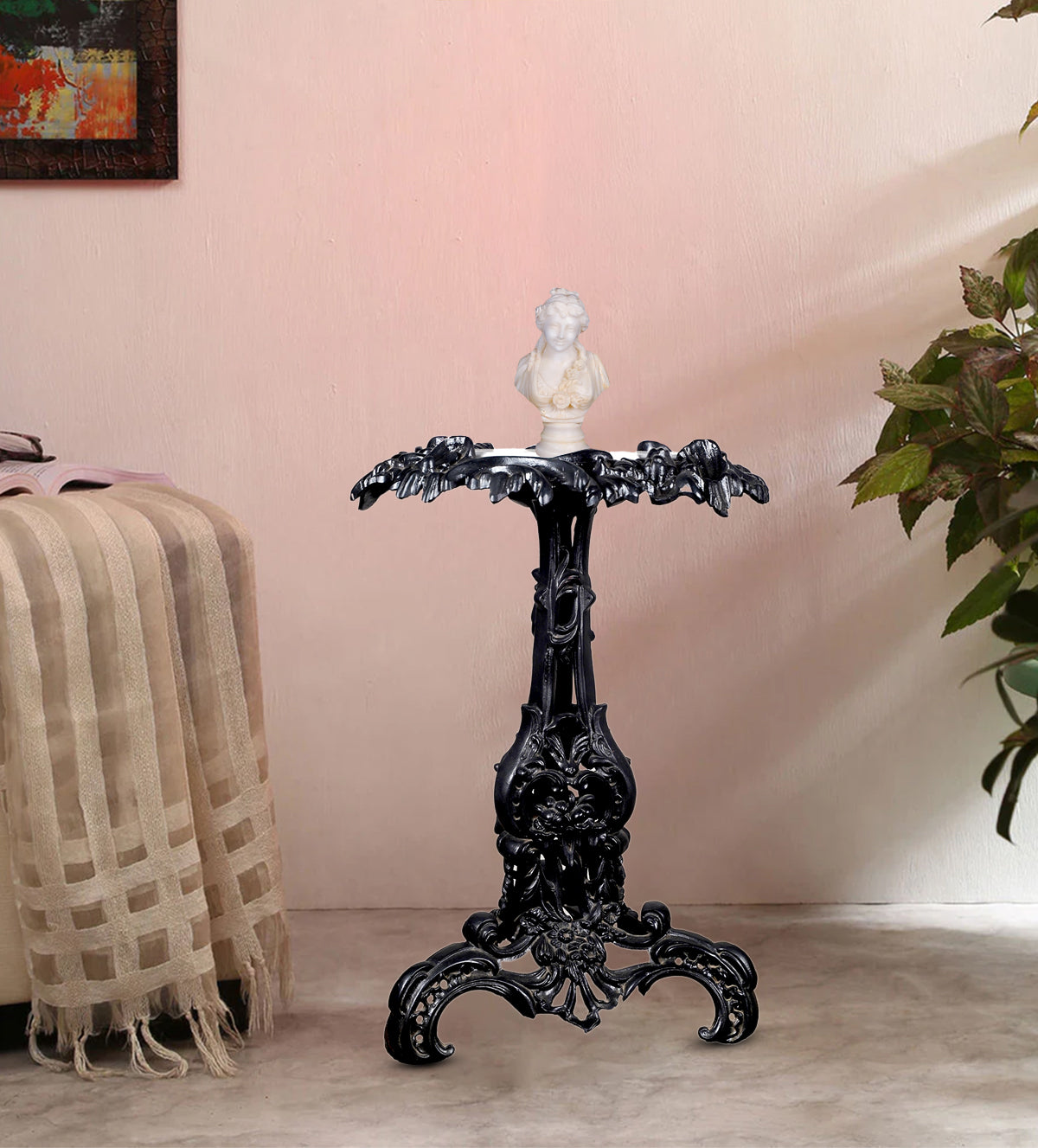 Antique pedestal table styled in a living room with a sculpture