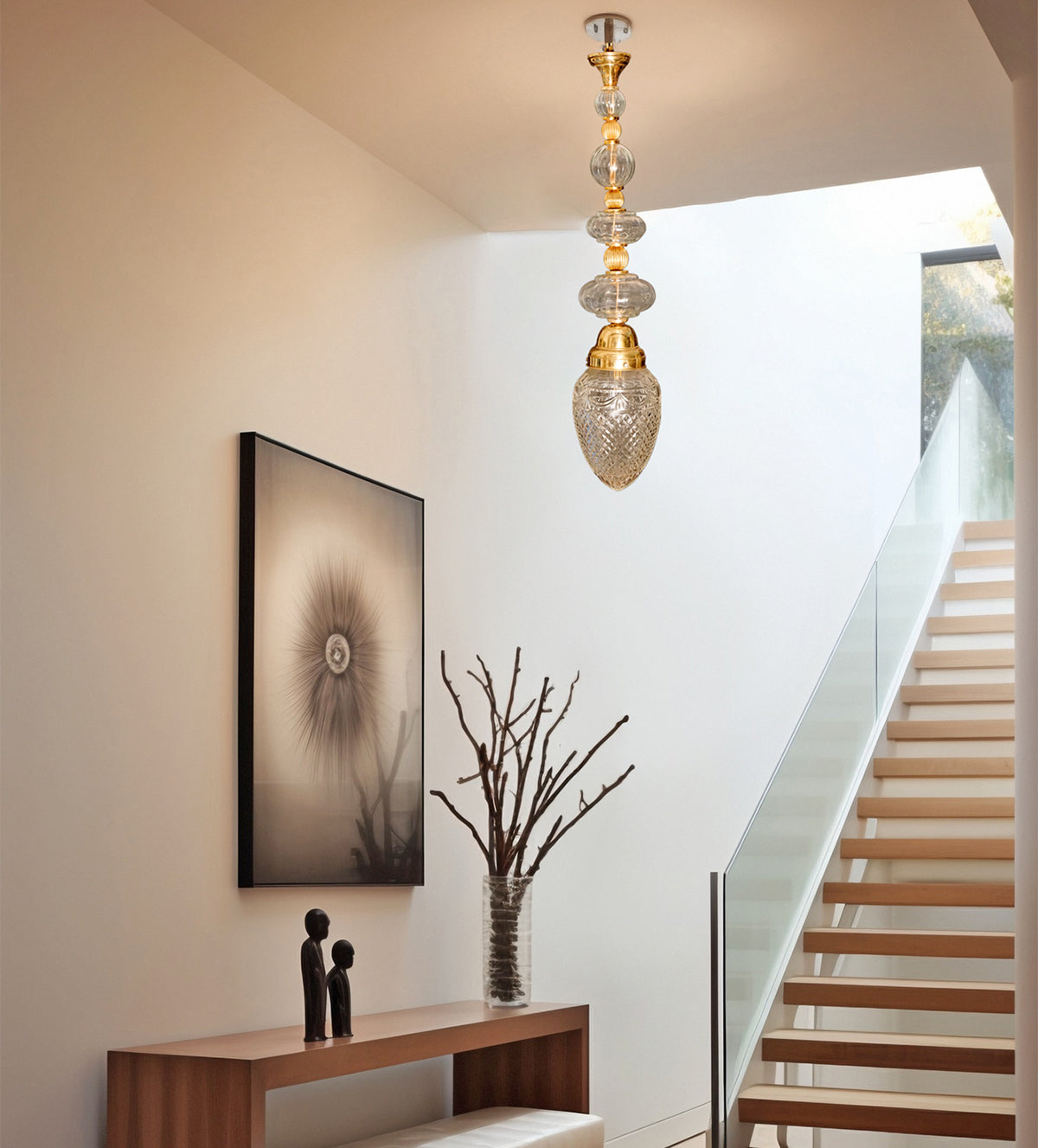 Imperial Brass Crystal Pendant Light with intricate brass accents and shimmering crystal globes, creating a luxurious, warm ambiance ideal for high-ceiling spaces.