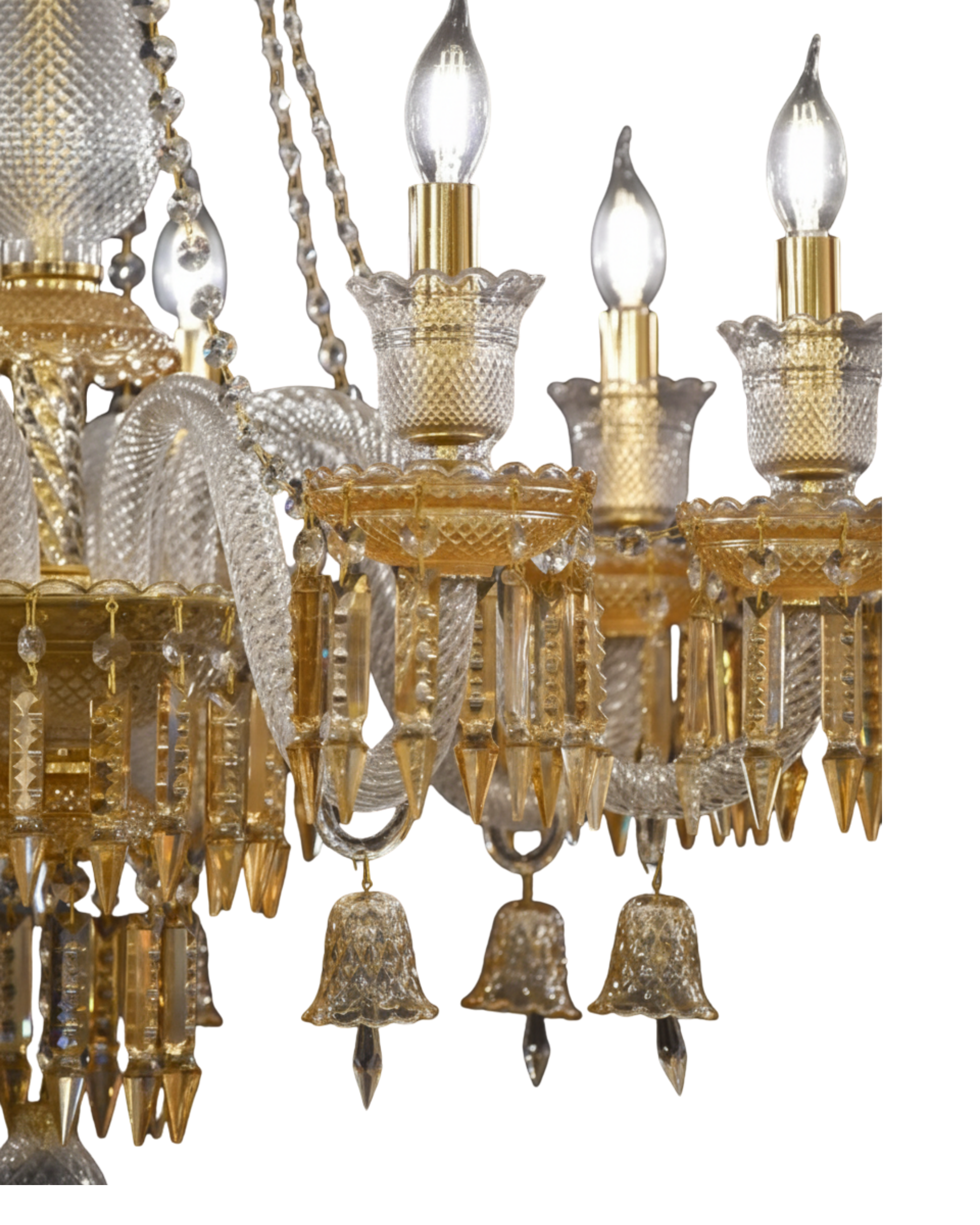 Close-up of a gold and crystal chandelier with three lit bulbs.
