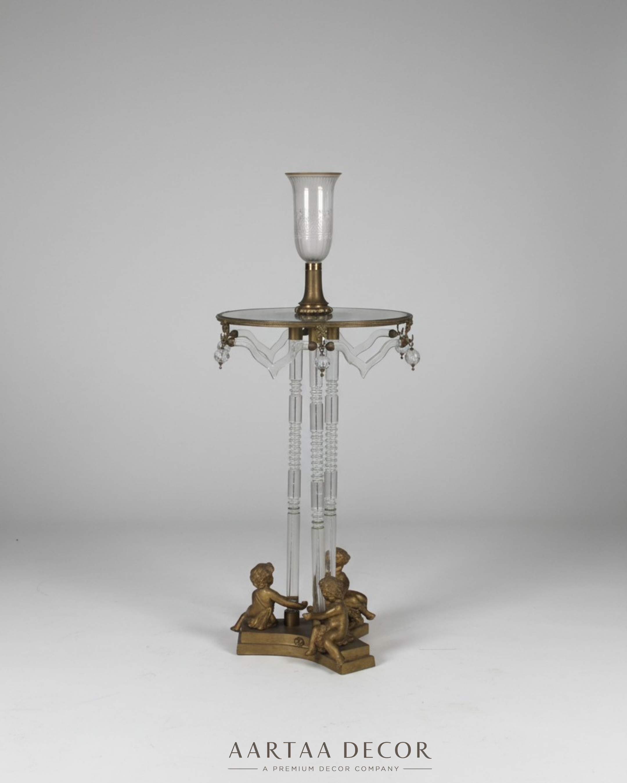 Studio photo of Cherub Crystal Pedestal Table by Aartaa Decor – handcrafted in India with crystal pedestal legs, brass cherub base, and glass top with crystal drops.