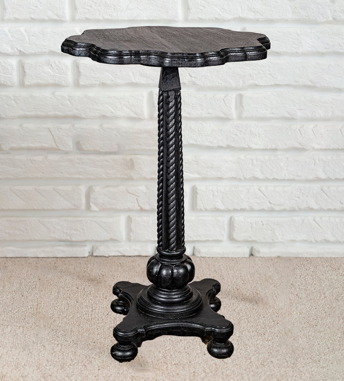 Close-up of ornate black wooden table base with ball feet – Aartaa Decor