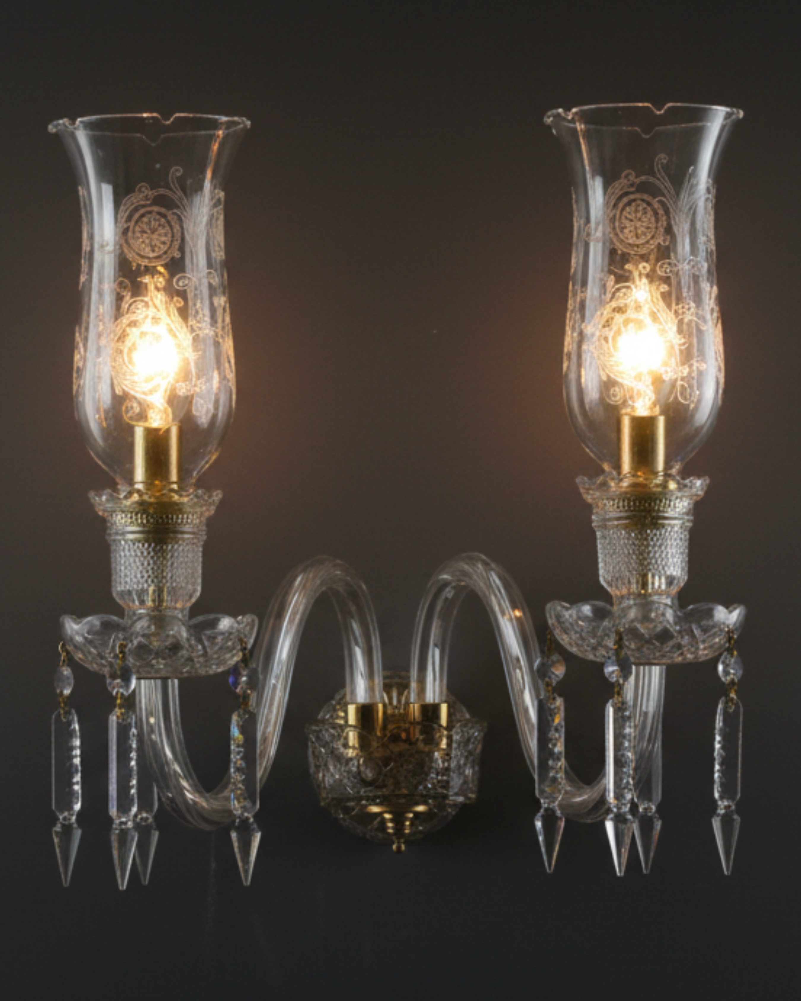 Pair of crystal wall sconces with glass shades on a dark background Handcrafted twin-arm wall light made in India.
