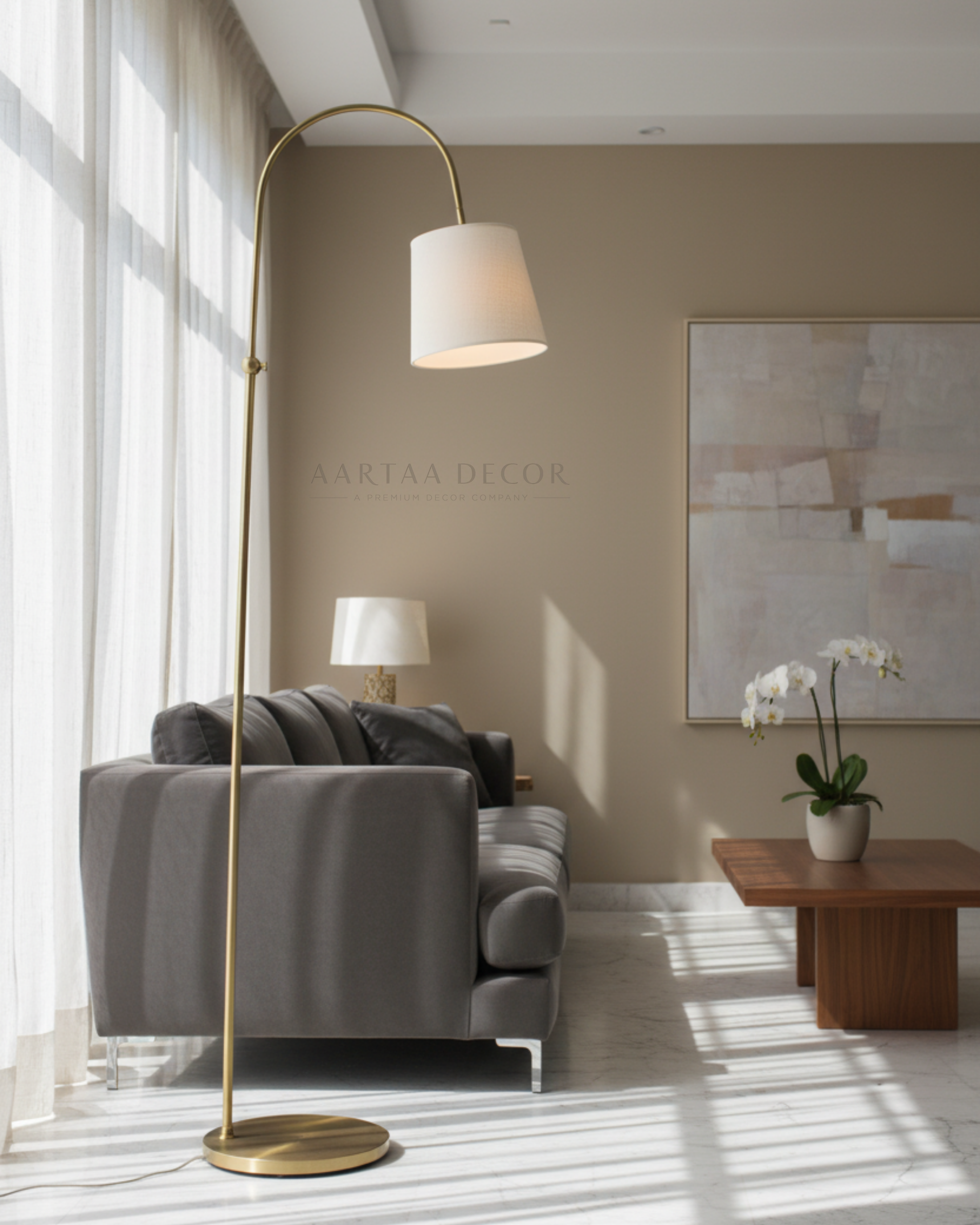 Modern living room with a gold floor lamp, gray sofa, and abstract art on the wall.