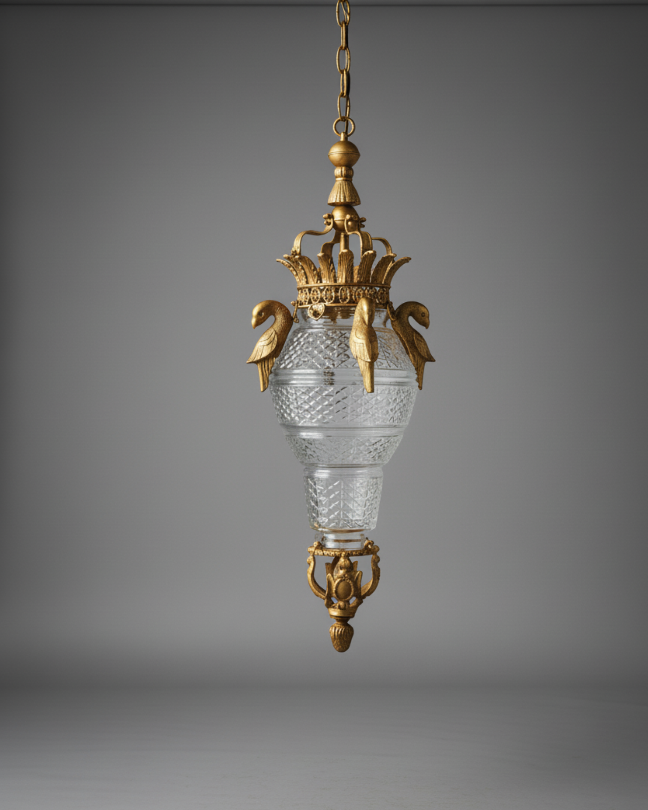 Decorative hanging lamp with gold and crystal design on a gray background