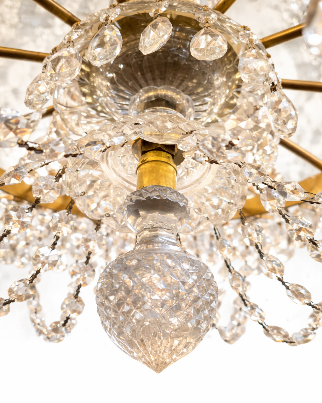 Close-up of a crystal chandelier with gold accents