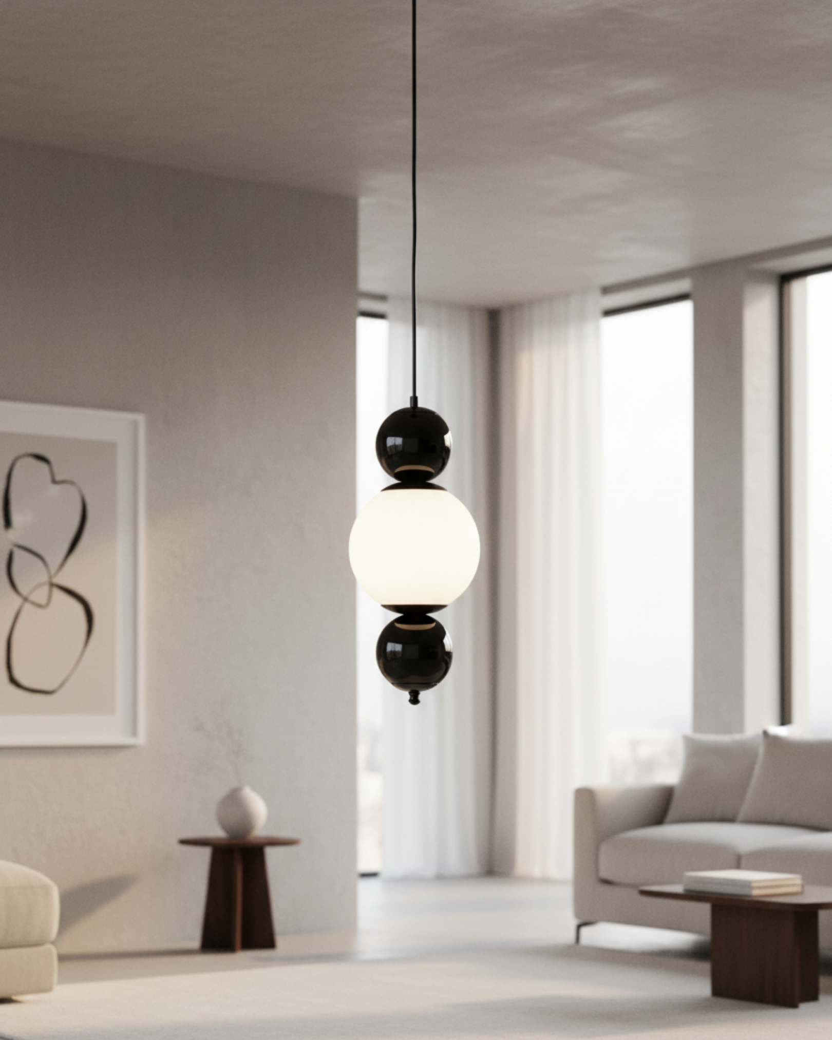 Modern interior with a pendant light fixture in a living room setting the Noor Orb Pendant Light is a statement of understated luxury. The design features a luminous handcrafted glass sphere, framed gracefully by solid brass accents that add warmth, contrast, and durability.