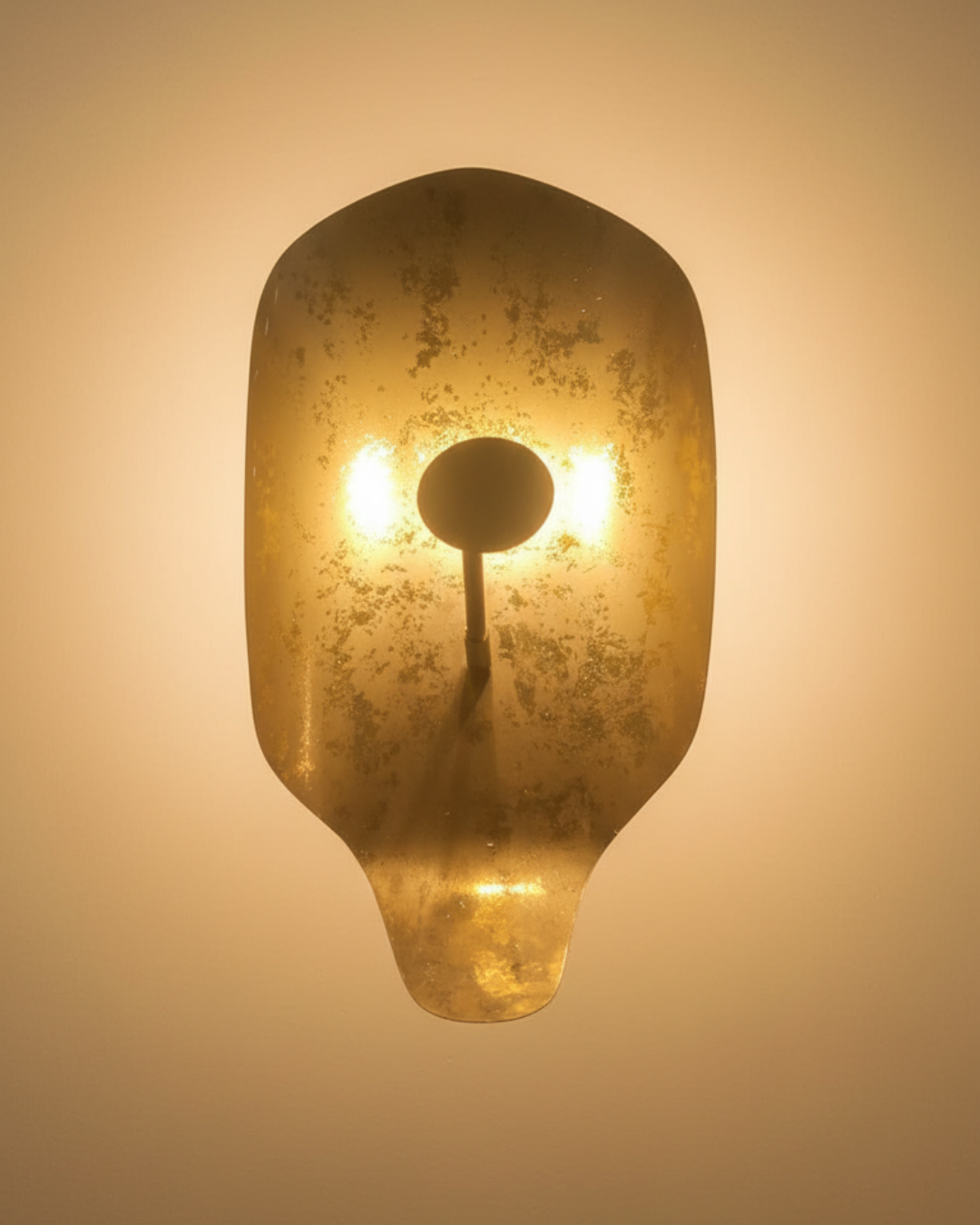 Decorative wall light fixture with a textured, amber glass shade on a beige background