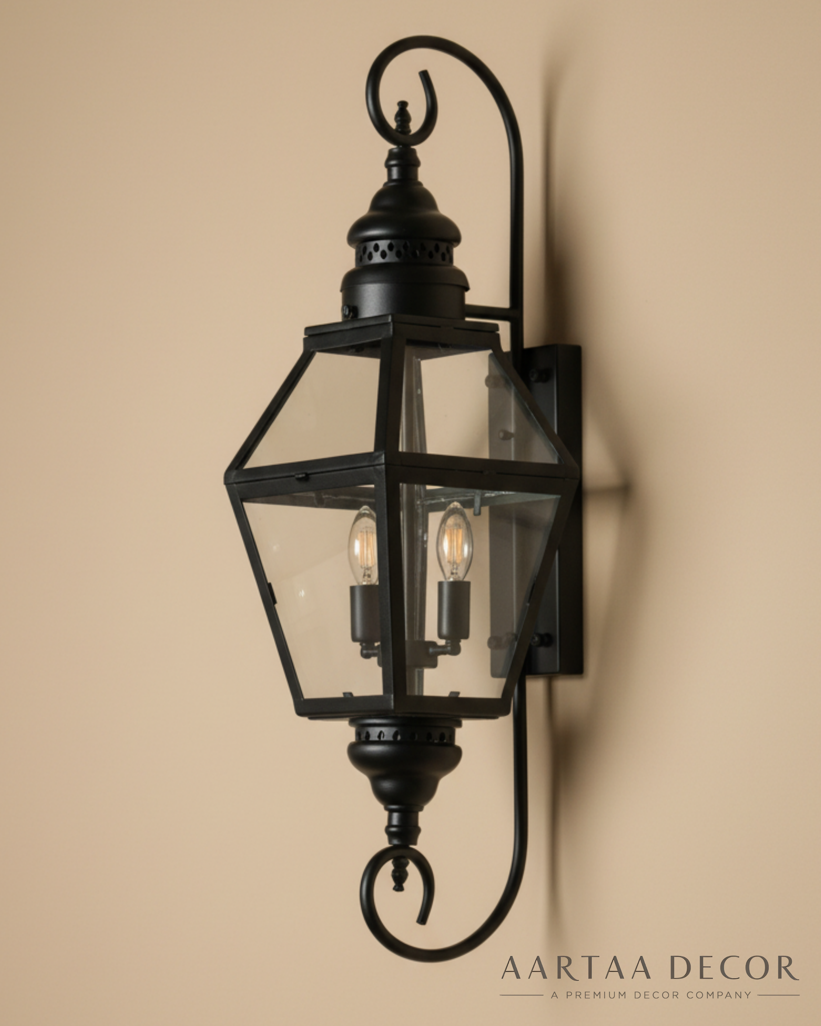 Decorative outdoor wall light fixture on a beige wall with 'Aartaa Decor' branding.