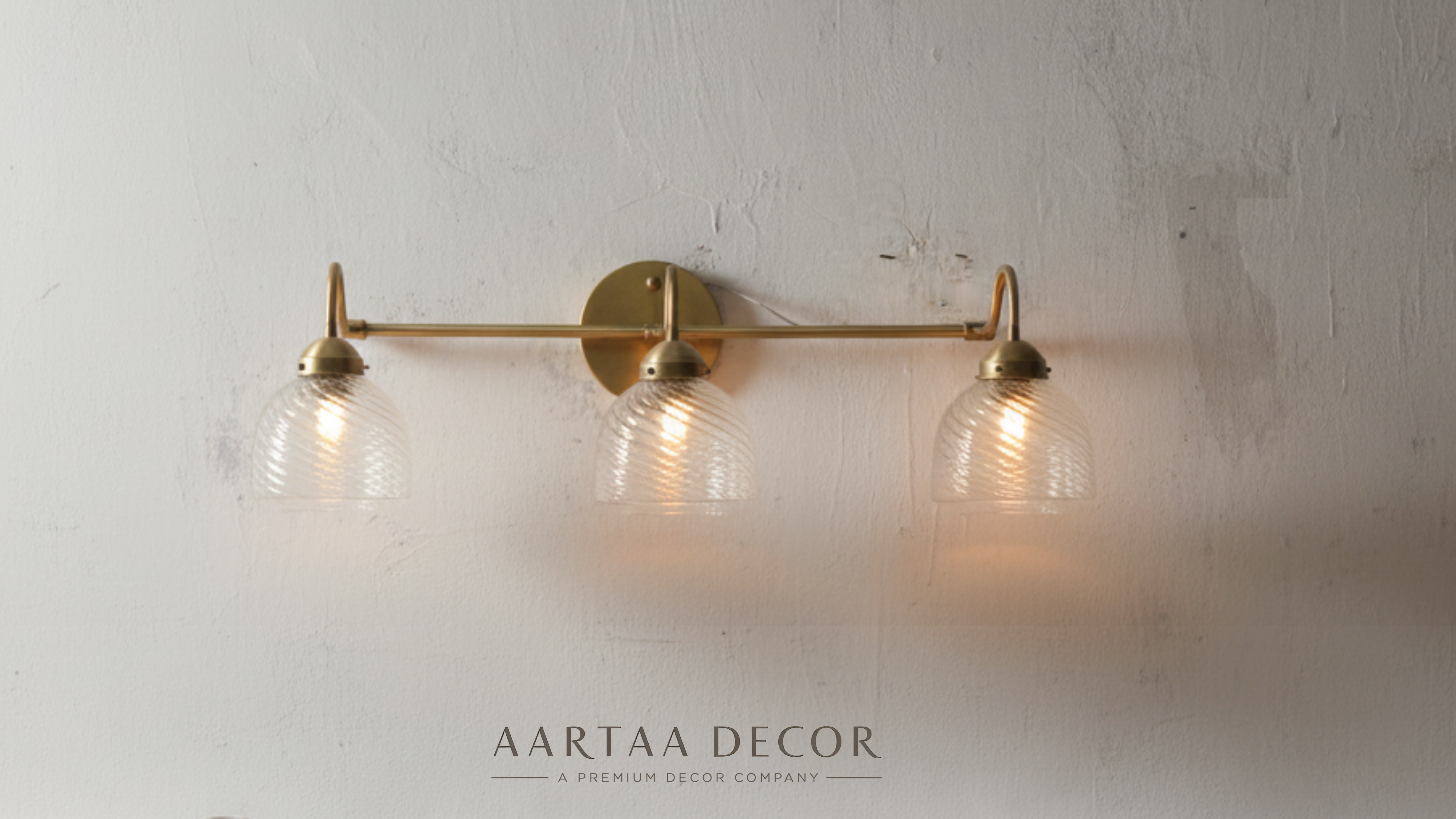 trio Glow Vintage Wall Light mounted above ornate mirror in classic living room, brass and glass wall light adding warm ambient glow to home décor.