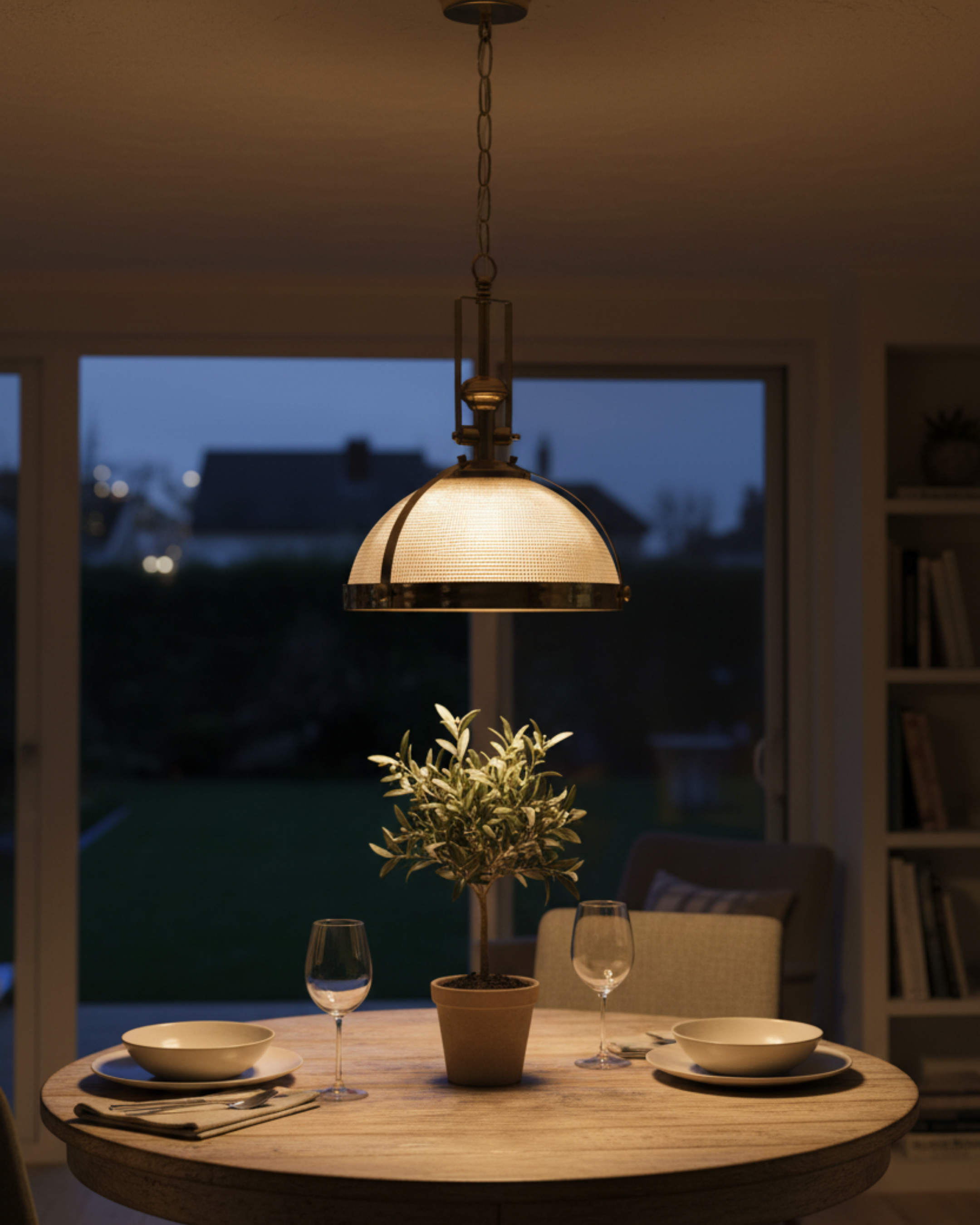 Vintage Brass Dome Pendant Light by Aartaa Decor hanging above a round wooden dining table, creating a warm and cozy ambiance.