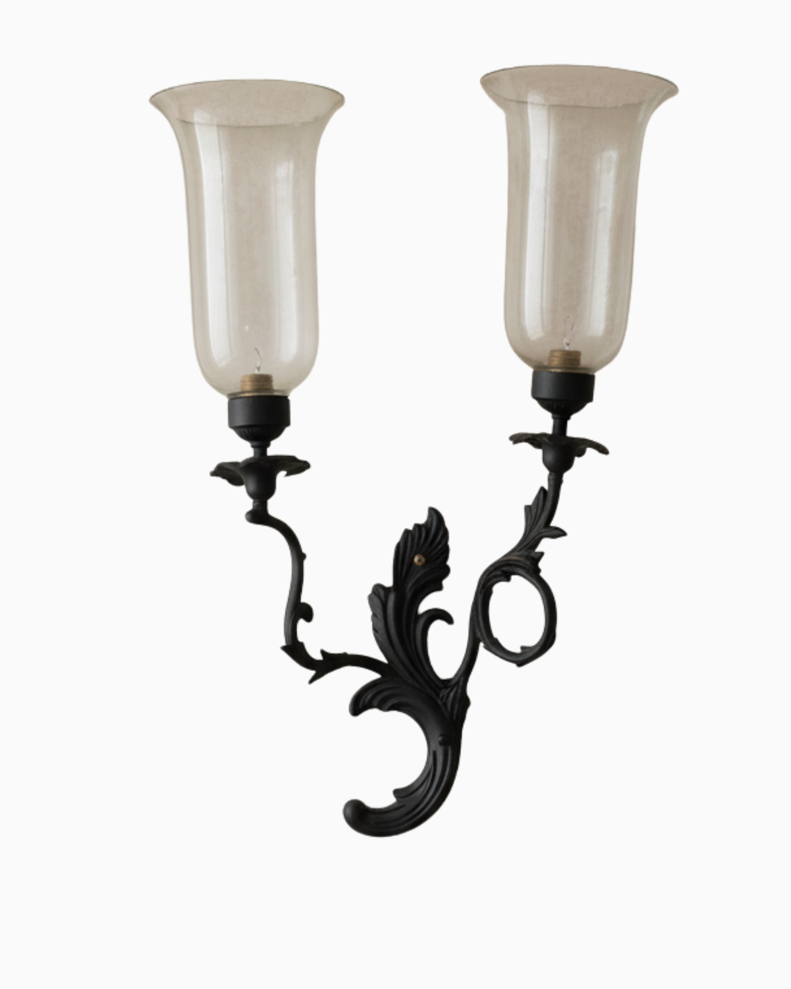 Decorative wall sconce with two glass shades on a white background