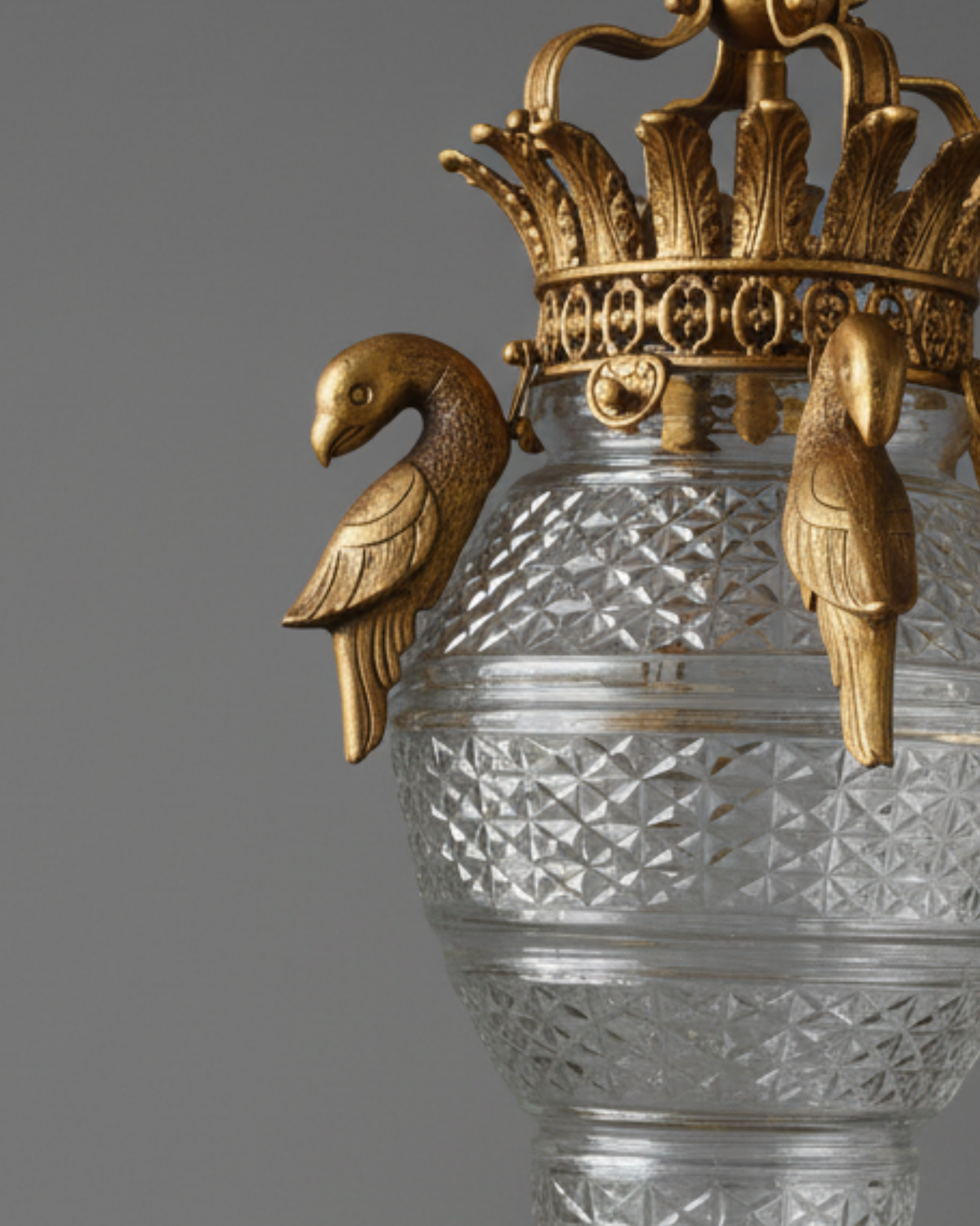 Heritage-inspired crystal pendant light with swan crown detailing and antique brass finish by Aartaa Decor.