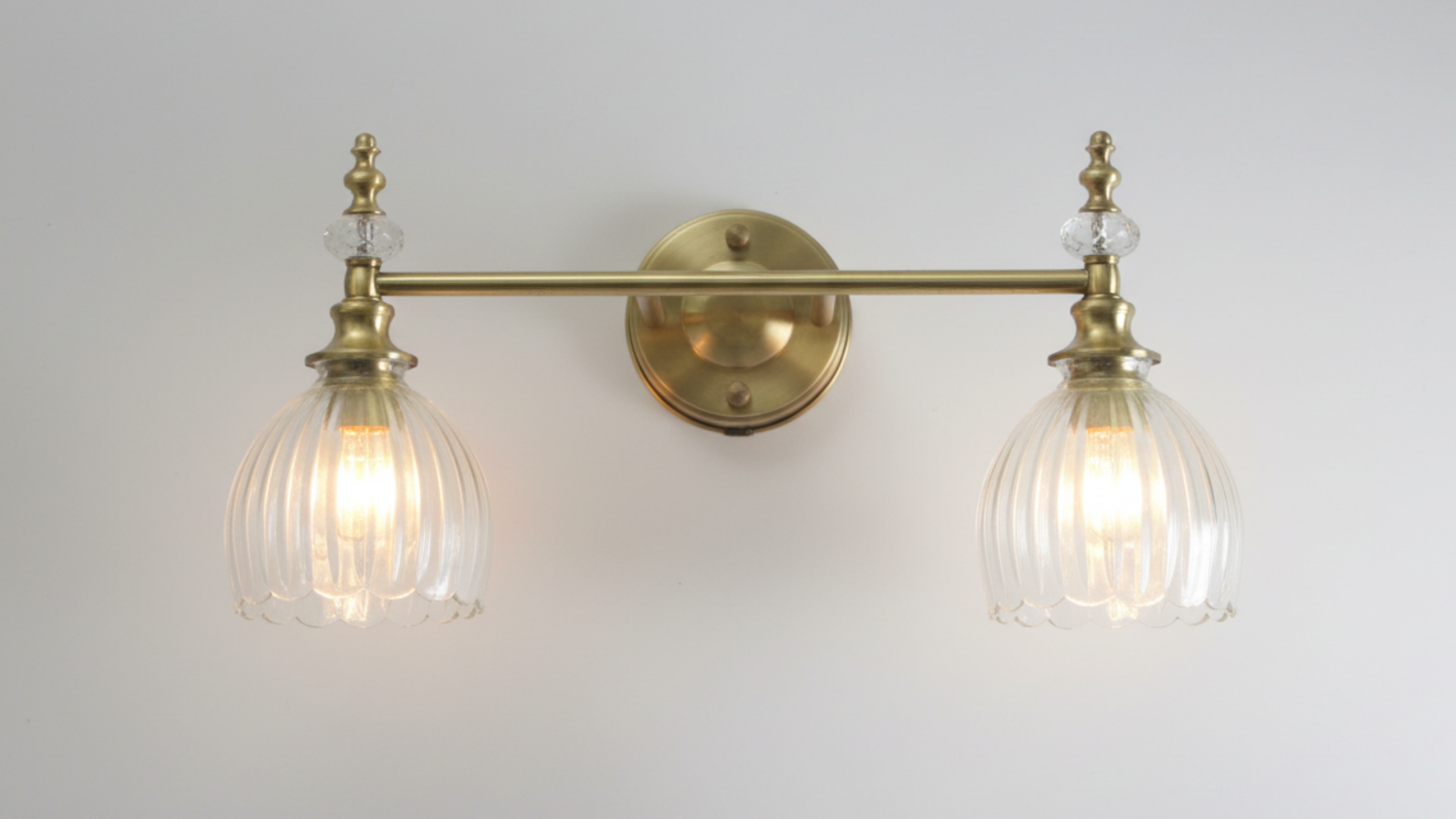 Luxury Crystal Crown Double Wall Light mounted on wall – antique brass frame with hand-blown glass shades in living room interior