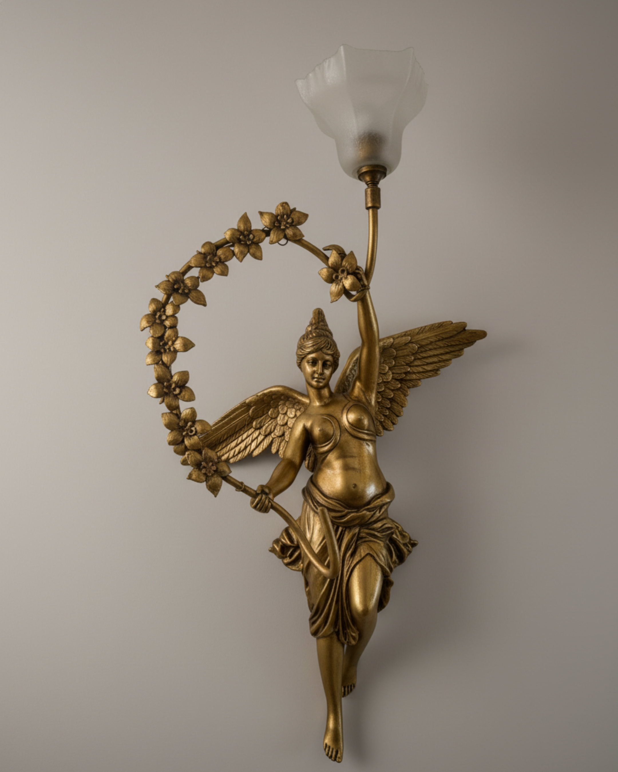 Devika Royale Celestial Wall Sconce Decorative wall sconce with angelic figure design on a plain background