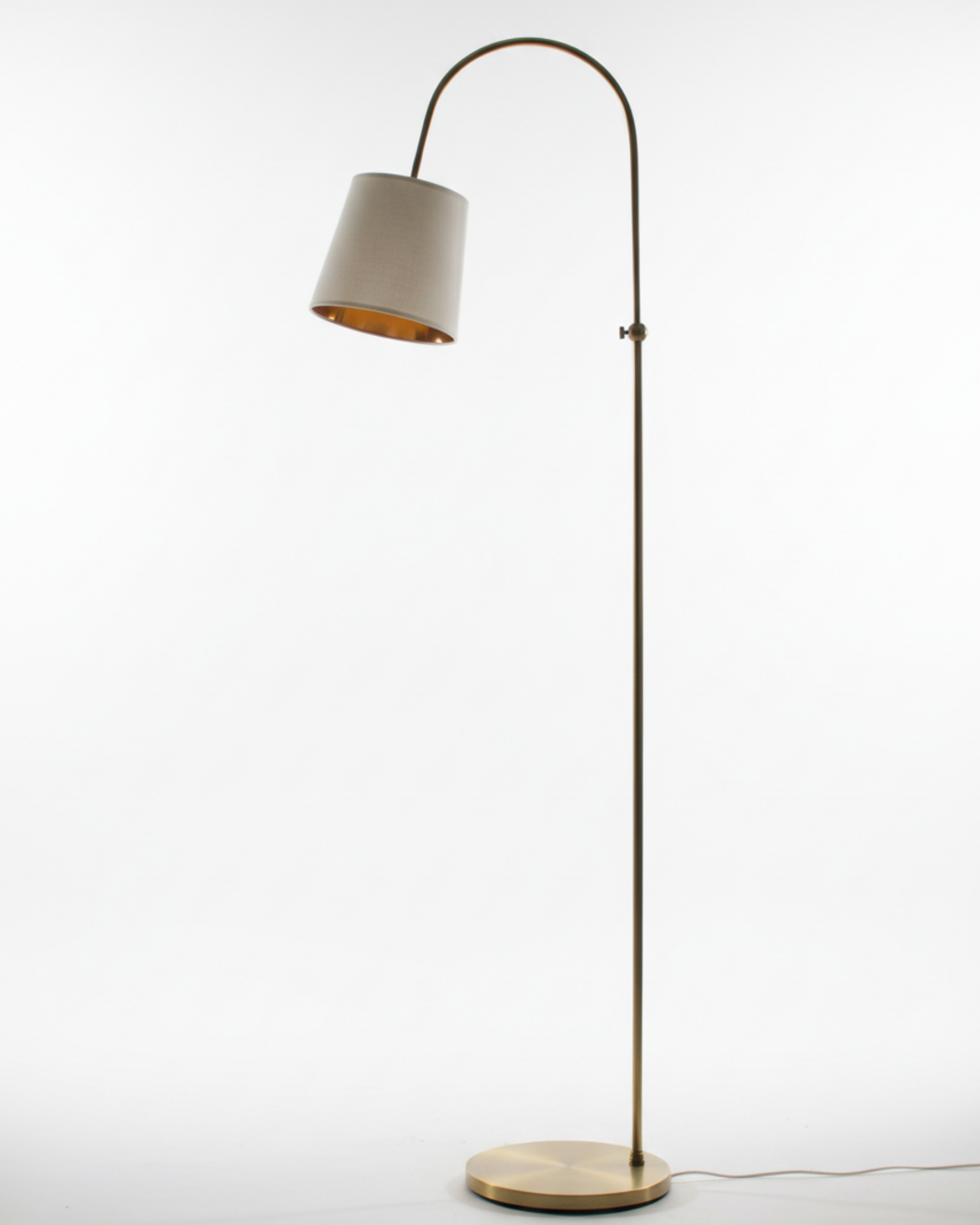 Floor lamp with a beige shade and base on a white background