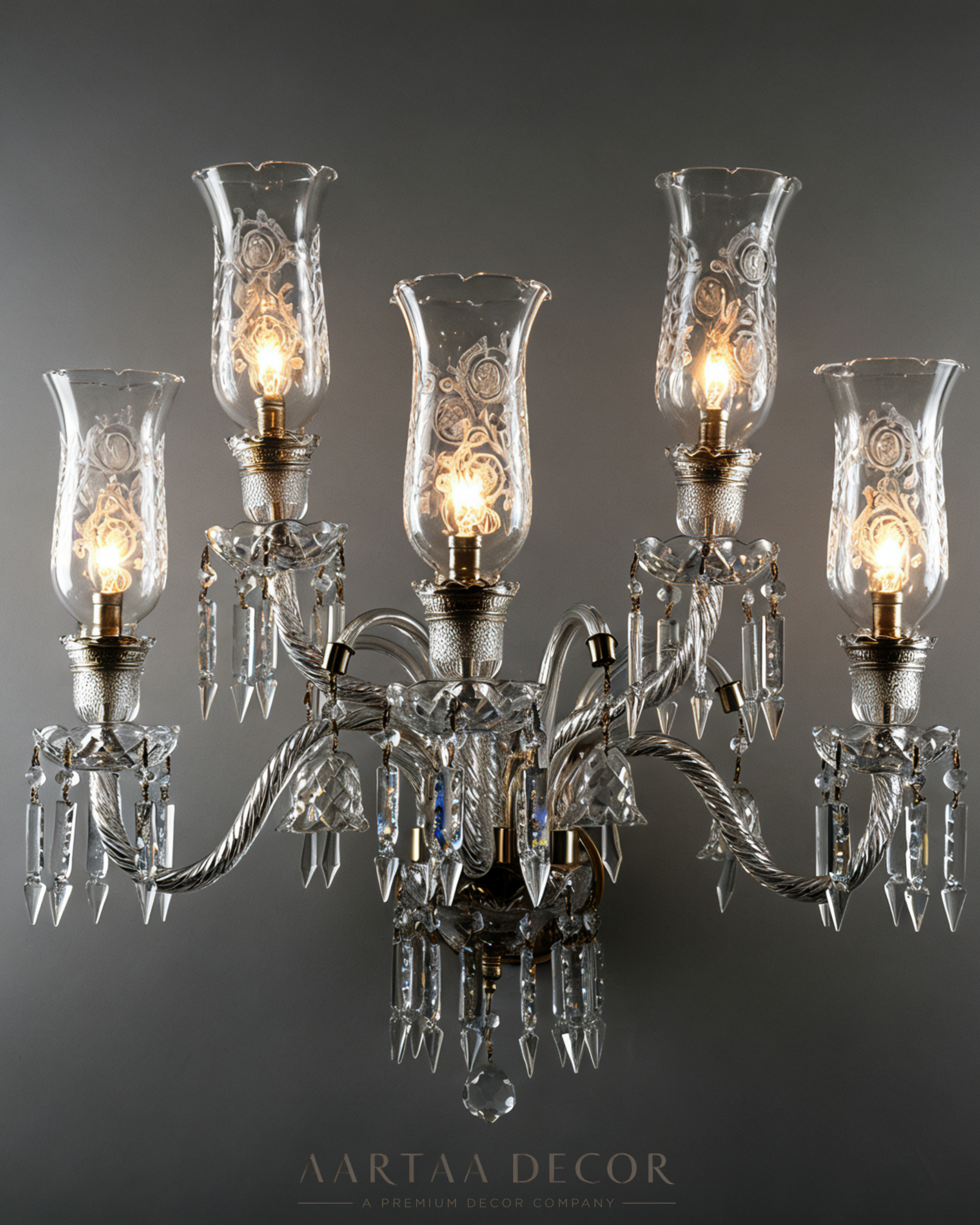 Chandelier with clear glass shades and visible brand 'Aartaa Decor' on a dark background