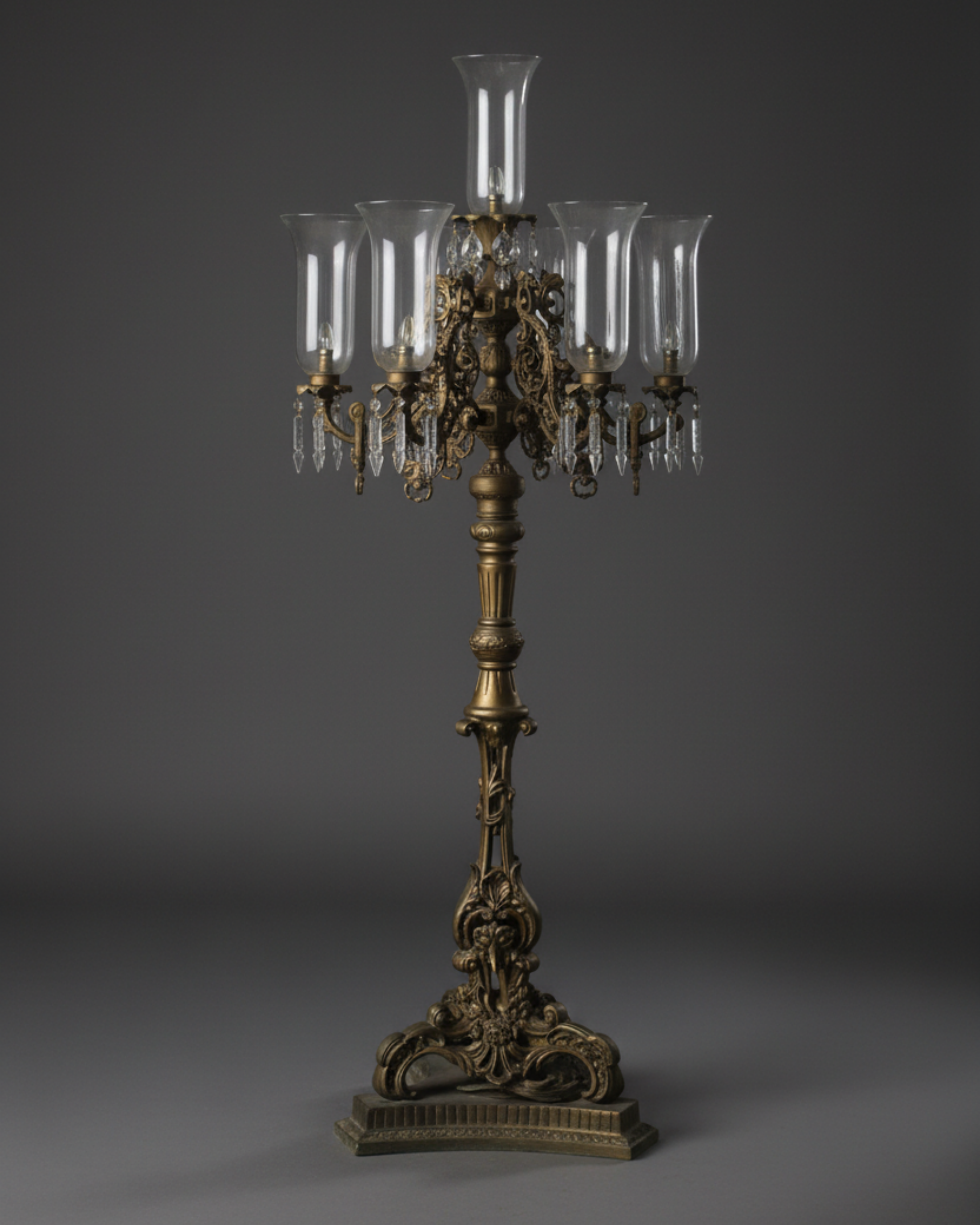 Decorative candelabrum with glass shades on a dark background